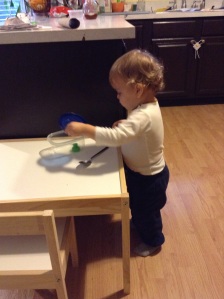 We're going to have to get some kind of play kitchen for this boy. He is obsessed with kitchenware.